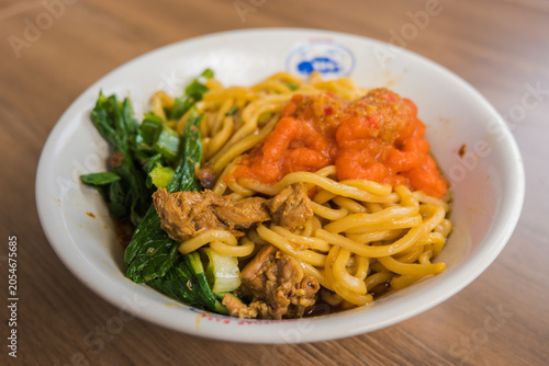 Traditional Indonesian Chicken Noodles with Vegetables in White Bowl