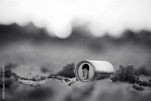 Littered Beverage Can in Barren Landscape Monochrome Close Up