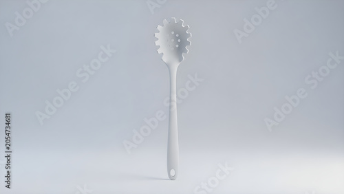 A single white toothbrush stands upright on a plain surface indoors.