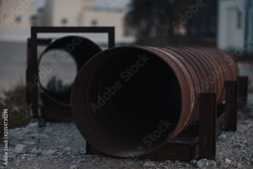 Rusted Corrugated Metal Pipes on Gravel Site