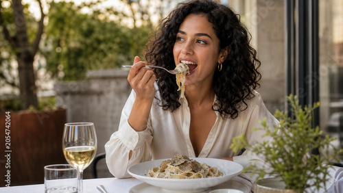Woman Eating Pasta At Outdoor Restaurant Terrace