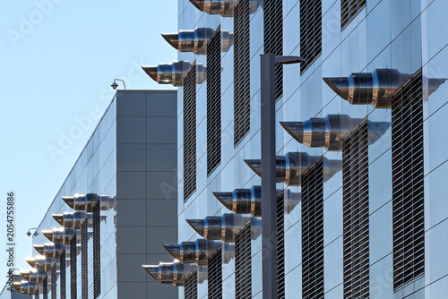 Exterior cooling system exhaust vents on a large data center building, representing thermal management, digital infrastructure, and cloud computing operations