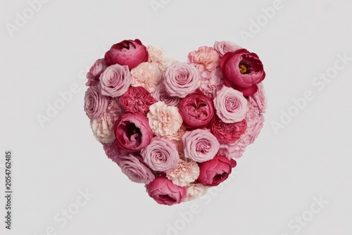 A beautiful heart shape formed by an exquisite arrangement of charming pink and rich maroon flowers