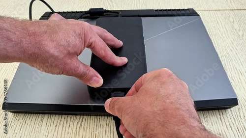 External SSD connected to a laptop through a USB adapter, showcasing portable storage, fast data transfer, modern computing technology, file management, and digital workflow