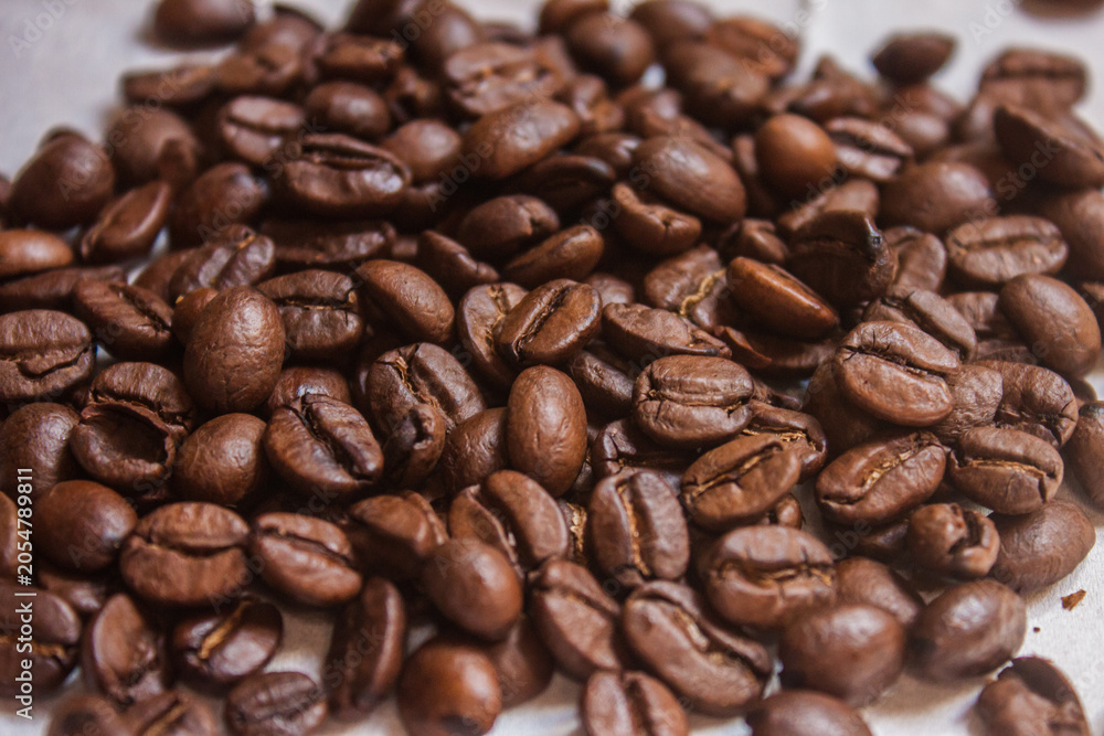 Fototapeta premium Coffee beans artistic shot, brown bean, arabica and robusta, café, caffeine, white background, freshness, shot is selective focus with shallow depth of field, taken at Cairo Egypt