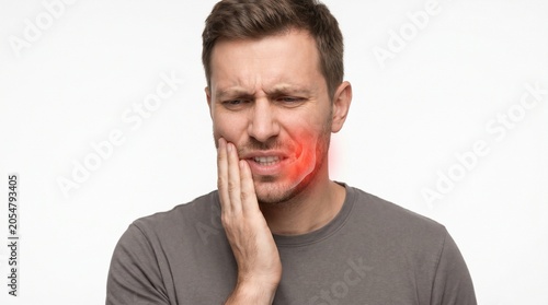Man Touching mouth with Hand Showing Discomfort and Pain in Neutral Indoor Setting