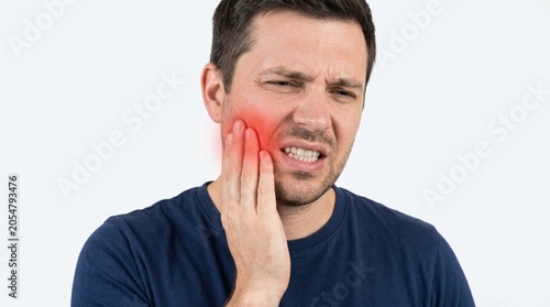 Man Touching Face with Hand Showing Pain or Discomfort in Indoor Setting