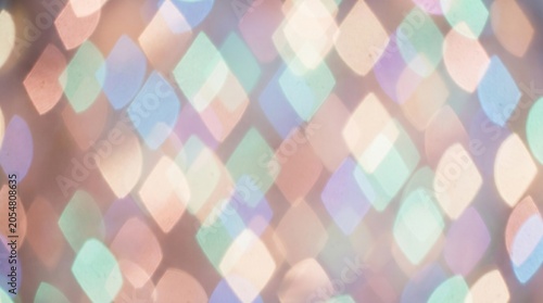 Abstract background with soft diamond shaped colorful bokeh lights.