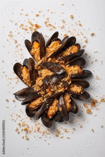 Plate of mussels with bread crumbs, top view