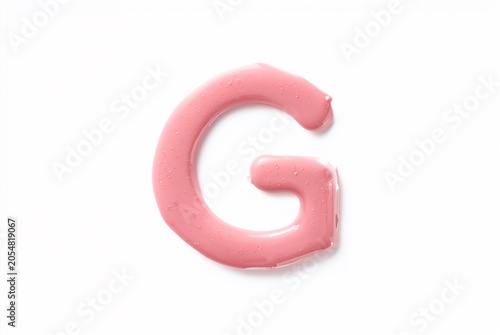 Pink liquid gel forming letter G on white background