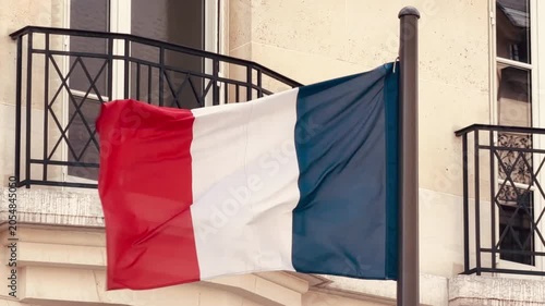 French flag waving in the wind in Paris, France