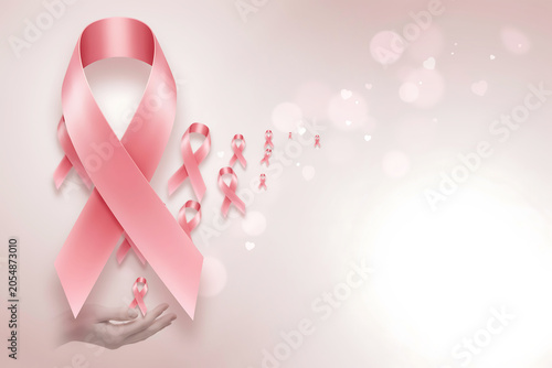 Pink ribbons symbol of breast cancer awareness support and hope with a gentle caring hand