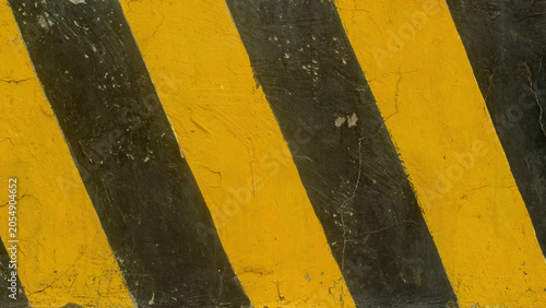 Quadro su tela Yellow and black diagonal stripes on concrete wall texture background for indust