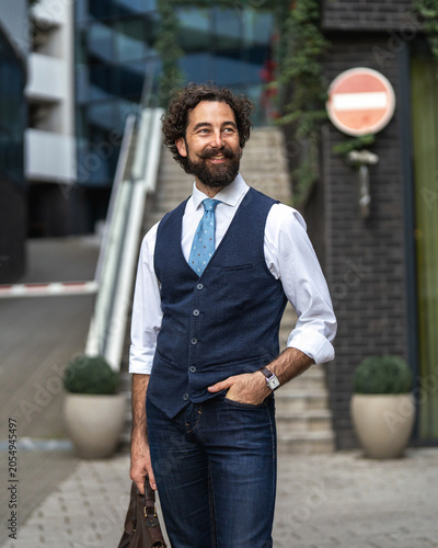 Tableau sur toile Stylish man with beard and mustache in urban setting