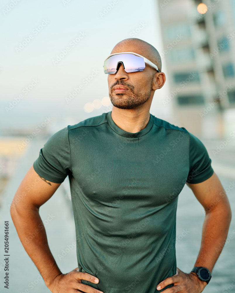 Naklejka premium Portrait of a young man runner prepering for fitness exercise wearing vr glasses outdoors