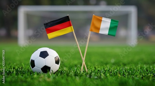 Two National Flags and Soccer Ball on Green Field with Goal in Background