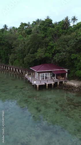 Aerial view of Tropical beach resort with overwater bungalow. Luxury overwater villas on blue lagoon, white sandy beach in Weh island, Sabang Aceh, Indonesia