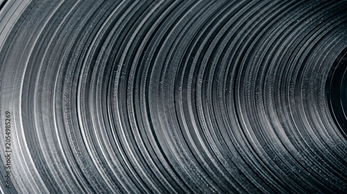 Vinyl record groove spiral raking light, groove modulation dust slate grey macro