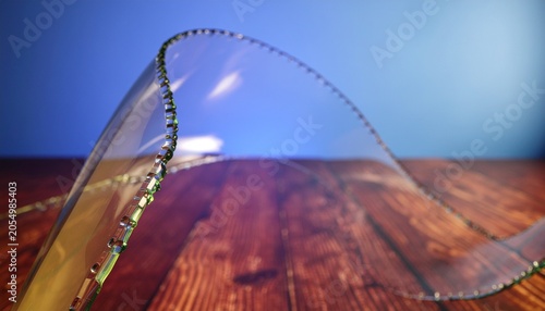 Elegant curved transparent glass sculpture on wooden surface with sculpture transparent minimalist abstract