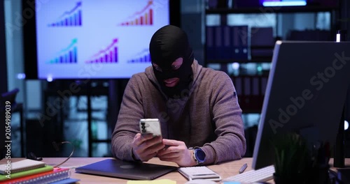 Emotional scammer in mask threatens to user by video call in office. Internet fraud angry over illegal deal fell through via cellphone at desk