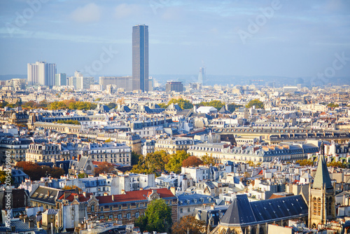 Foto Panoramic view of Paris rooftops with Montparnasse Tower, church spire, classic