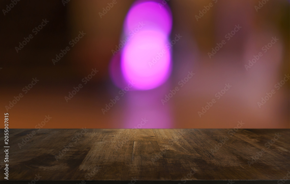 Naklejka premium Empty wood table top and blur of restaurant background selective focus product display