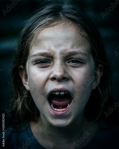 Young girl screaming expressing anger and frustration