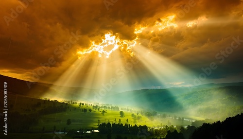 Intense volumetric sun rays breaking through dark storm clouds over a green valley landscape