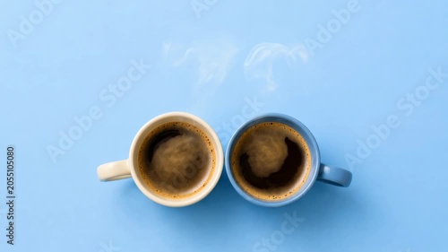 Coffee cups with heart-shaped steam on blue background for romantic coffee moments