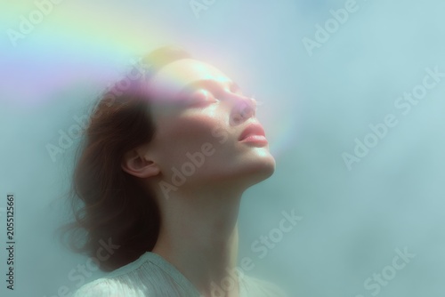 Woman inhaling soft rainbow light for breathwork magic and healing meditation background or wellness poster design