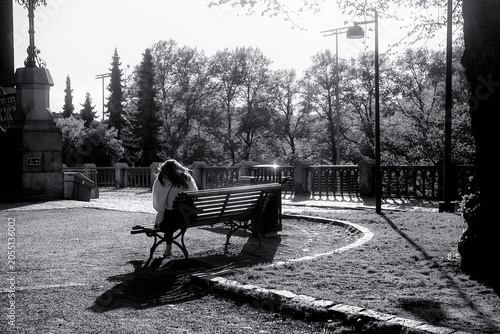 Woman Sitting on a Bench in Evening Sunlight