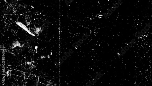 Dark grunge overlay texture featuring white scratches, dirt, and messy dust particles on a black background. Abstract damaged film grain effect for retro cinematic video and photography