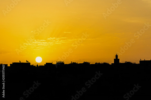 Golden Sunset Over Meknes Skyline with Mosque Minaret Silhouette, Morocco
