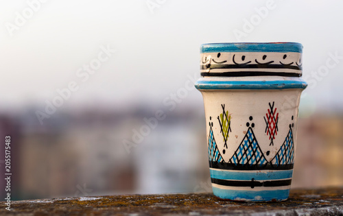 Schilderij op canvas Traditional Handmade Moroccan Ceramic Tea Cup on a Rooftop in Meknes