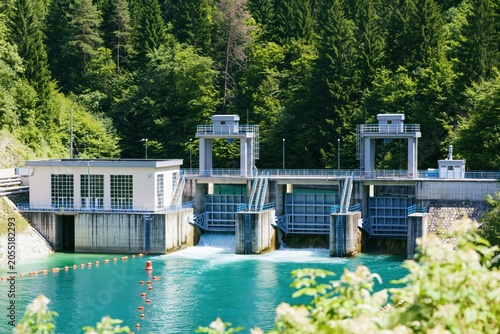 Hydroelectric Power Station With Turquoise Water And Green Forest