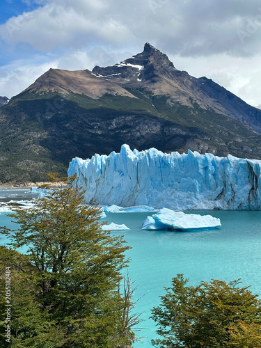 Turquoise waters and towering glacier ice at Perito Moreno Glacier, Patagonia, Argentina. Scenic mountain backdrop, floating icebergs, and pristine wilderness highlight this iconic natural landmark.