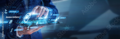 Tableau sur toile Corporate strategist working on tablet utilizing Business Intelligence