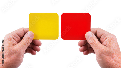 Foto Isolated referee hands holding yellow and red penalty cards for sports game deci