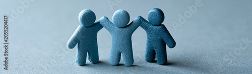 Three blue figures in unity...