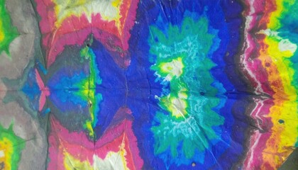 Colorful kaleidoscopic tie-dye fabric pattern with vibrant rainbow colors.