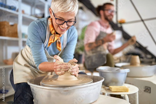 elderly woman artist making pot from wet clay. Business, art, Creative, hobby ,workshop  concept