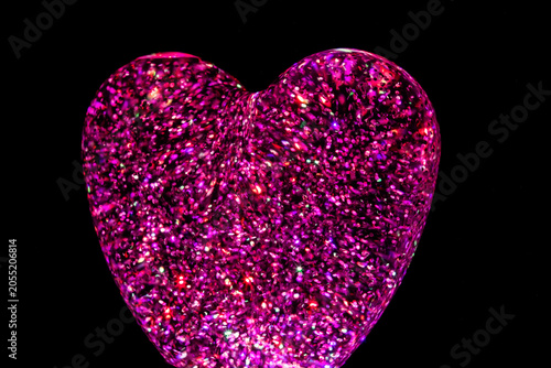 Fotografie a heart-shaped glass paperweight filled with holographic Iridescent glitter part