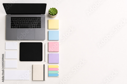 Background of Laptop computer and stationery arranged on a clean modern office desk in flat lay style