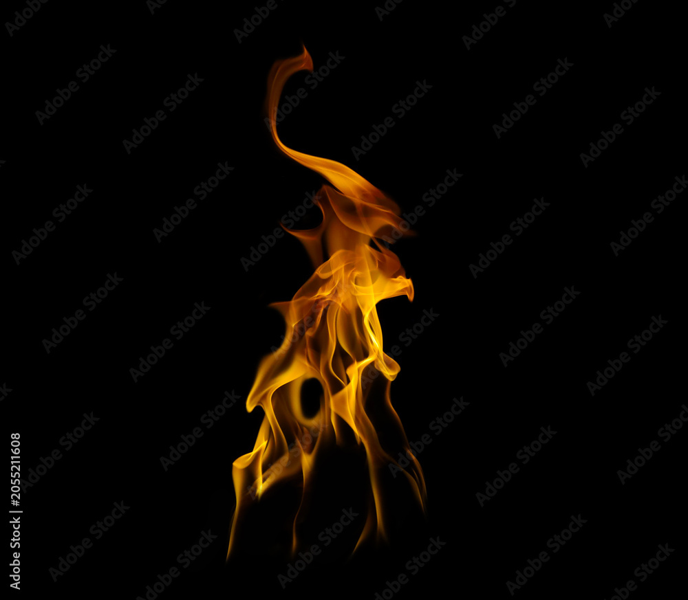 Fototapeta premium A vibrant isolated fire flame burning with orange and yellow hues against a pitch-black background. This high-quality dynamic blaze is perfect for creative composite designs, overlay effects.