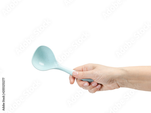 Woman's hand holding a spoon on the white background.