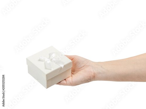 Woman's hand holding a gift box on her palm with the white background.