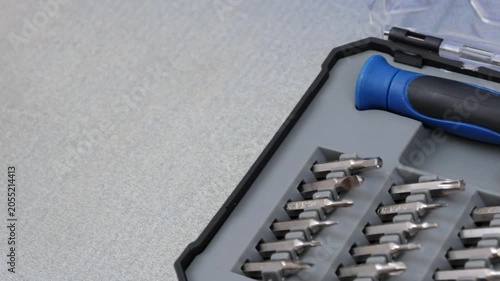 A set of metal bits for installation work in a plastic case.