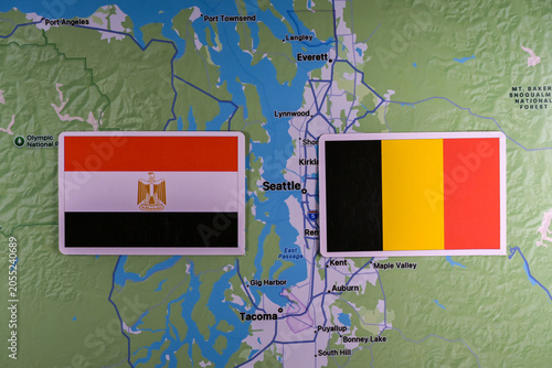 June 9, 2026, United States. Flags of the participants of the FIFA World Cup group stage of the national teams of Egypt and Belgium on the background of Seattle map.