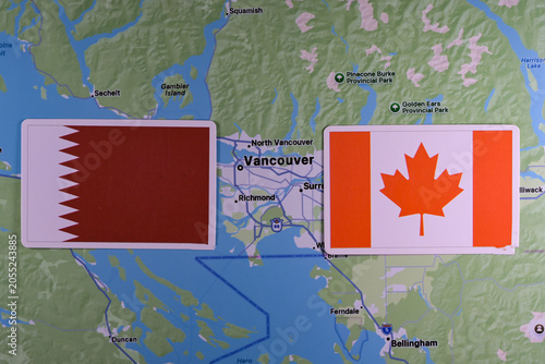 June 9, 2026, United States. Flags of the participants of the FIFA World Cup group stage of the national teams of Qatar and Canada on the background of the Vancouver map