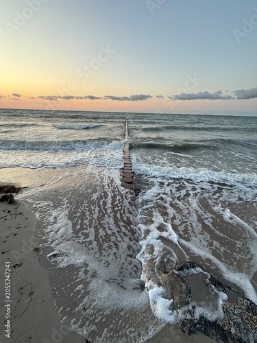 waves at the beach in sunset light in summer season